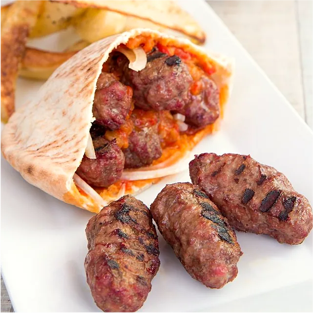 Cevapi links in pocket bread with red pepper sauce and onion