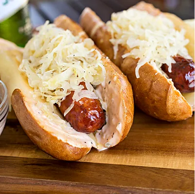 Kielbasa in a bun, topped with sauerkraut