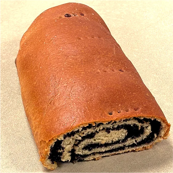 A poppy seed roll, cut to show the dark spiral
