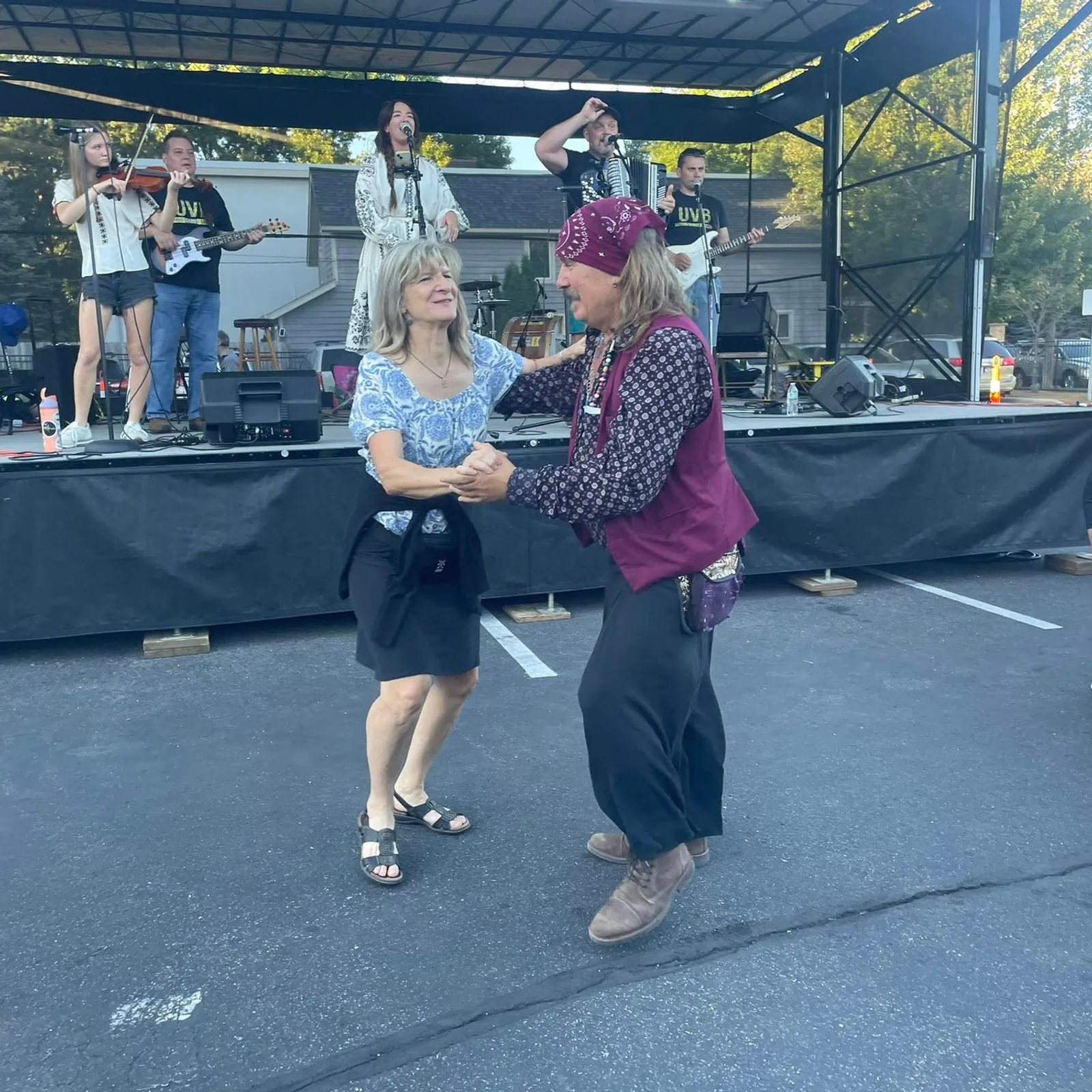 Guests dancing in front of the outdoor stage